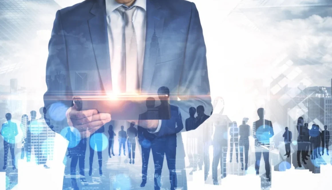 businessman-using-tablet-with-abstract-crowd-of-bu