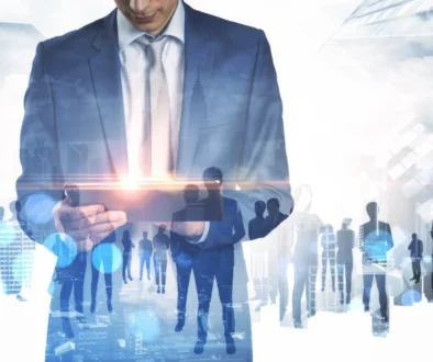 businessman-using-tablet-with-abstract-crowd-of-bu