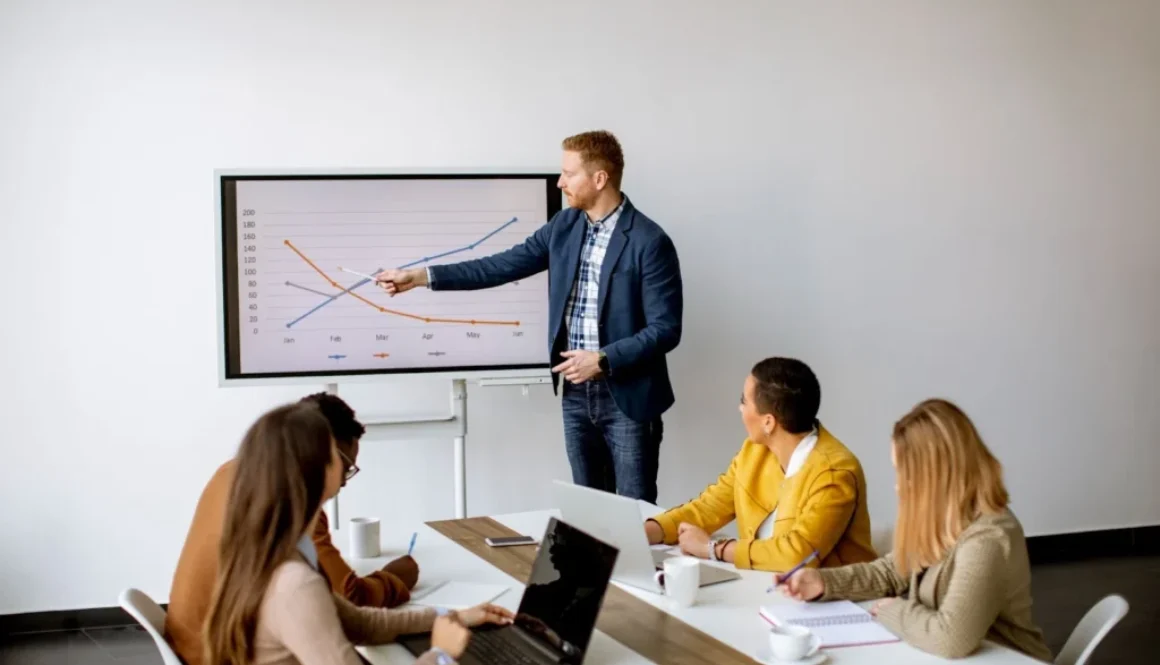 A business team in a meeting examines a chart that illustrates the financial implications of hiring full-time employees versus rightsourcing.